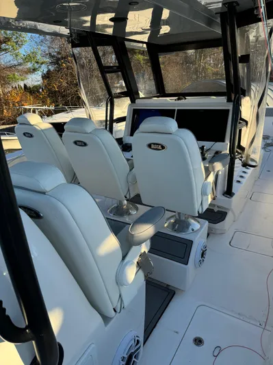  Yacht Photos Pics 2022 Invincible 40 Catamaran interior with white seating and modern dashboard.