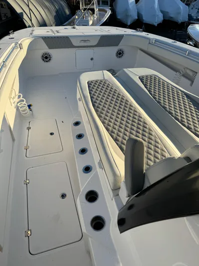  Yacht Photos Pics 2022 Invincible 40 Catamaran interior with diamond-stitched seating and multiple storage compartments.