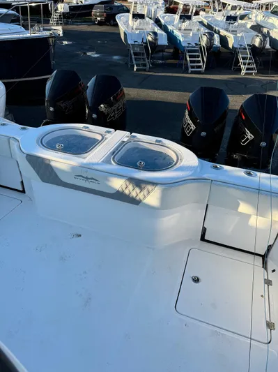  Yacht Photos Pics 2022 Invincible 40 Catamaran with multiple outboard engines, docked at a marina.