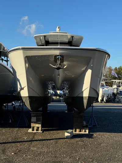  Yacht Photos Pics 2022 Invincible 40 Catamaran on display, front view under clear blue sky.
