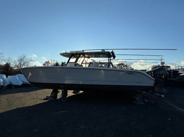  Yacht Photos Pics 2022 Invincible 40 Catamaran on land, side view, under clear blue sky.