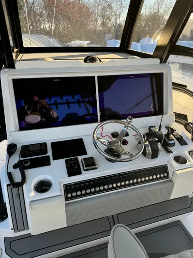  Yacht Photos Pics 2022 Invincible 40 Catamaran helm with dual screens and modern controls.