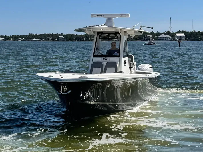  Yacht Photos Pics 2023 Regulator 28 boat cruising on a sunny day in calm waters.