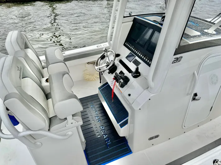 Yacht Photos Pics 2023 Regulator 28 boat cockpit with dual seats and modern control panel.