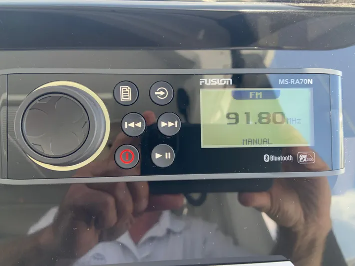  Yacht Photos Pics Fusion MS-RA70N stereo system displaying FM 91.80 MHz, in a 2025 Jeanneau NC 1095 Coupe.