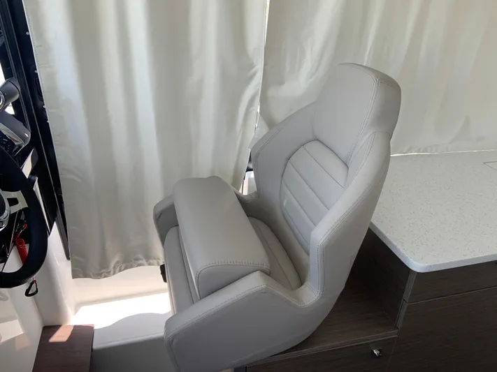  Yacht Photos Pics 2025 Jeanneau NC 1095 Coupe helm seat, luxurious design with light upholstery.