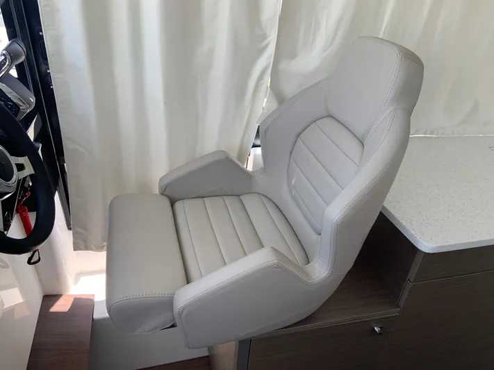  Yacht Photos Pics Captain's chair in 2025 Jeanneau NC 1095 Coupe, featuring sleek design and comfortable seating.
