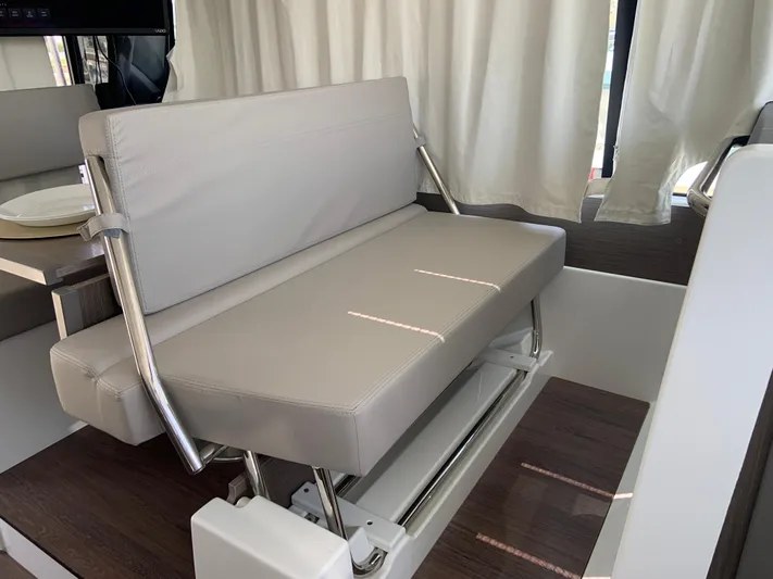  Yacht Photos Pics 2025 Jeanneau NC 1095 Coupe interior with modern seating and elegant design.