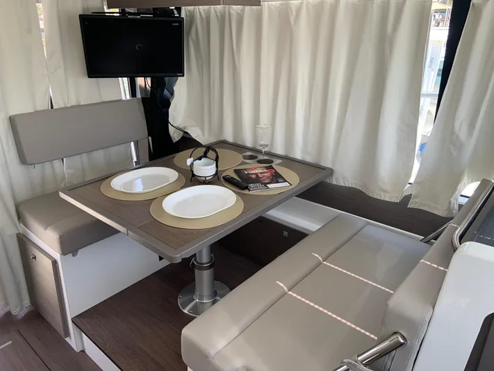  Yacht Photos Pics Interior of 2025 Jeanneau NC 1095 Coupe with dining area and TV.