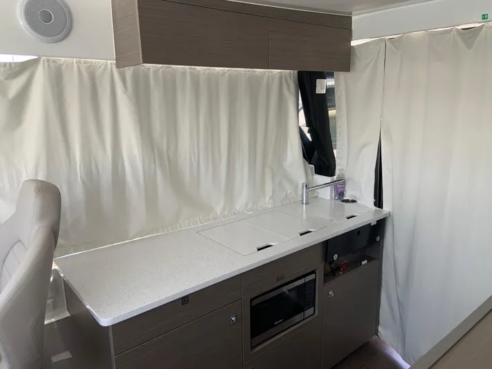  Yacht Photos Pics 2025 Jeanneau NC 1095 Coupe interior kitchen with modern cabinetry and appliances.