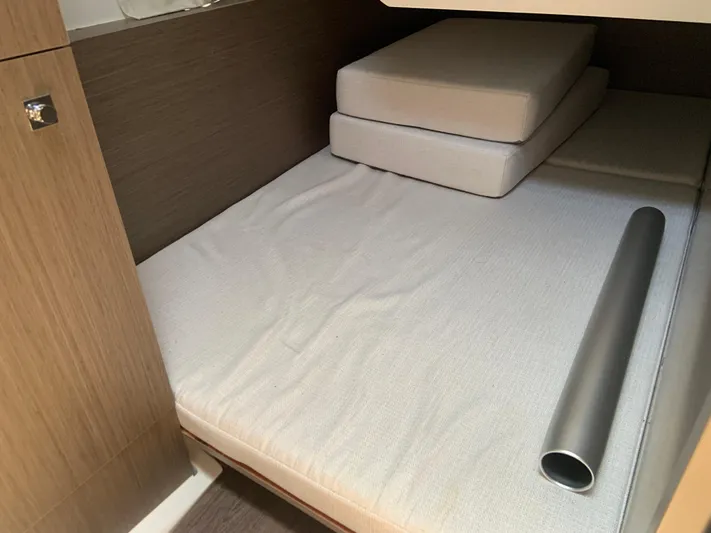  Yacht Photos Pics Interior cabin of 2025 Jeanneau NC 1095 Coupe with cushions and metal tube.