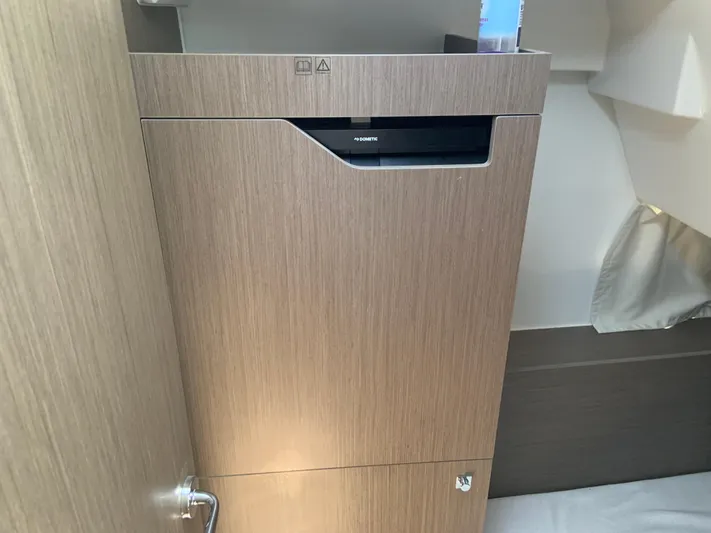  Yacht Photos Pics Interior of 2025 Jeanneau NC 1095 Coupe, featuring a sleek wooden cabinet design.