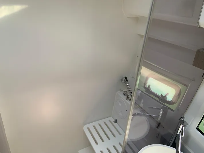  Yacht Photos Pics Bathroom interior of 2025 Jeanneau NC 1095 Coupe with shower and window.