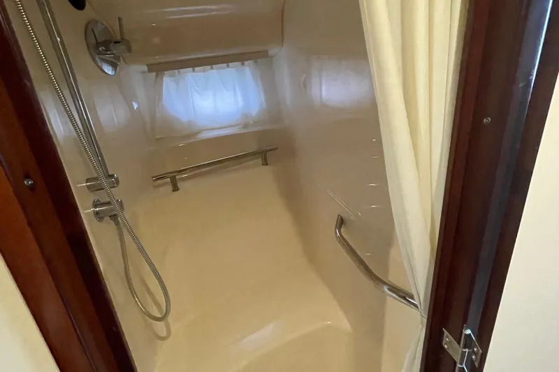 Maddie Janes Yacht Photos Pics Shower area in 2009 Sea Ray 40 Sundancer yacht with curtain and grab bars.
