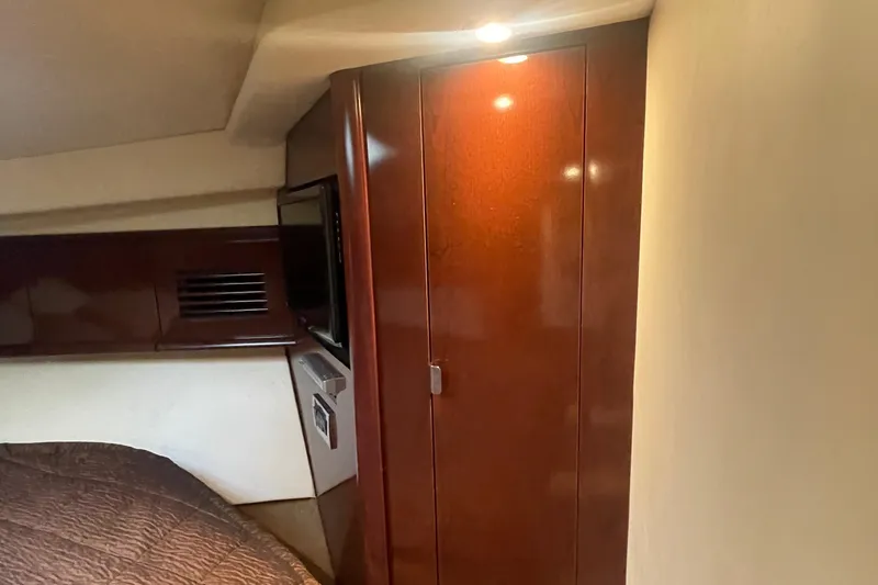 Maddie Janes Yacht Photos Pics Interior cabin of 2009 Sea Ray 40 Sundancer with wooden cabinetry and ambient lighting.