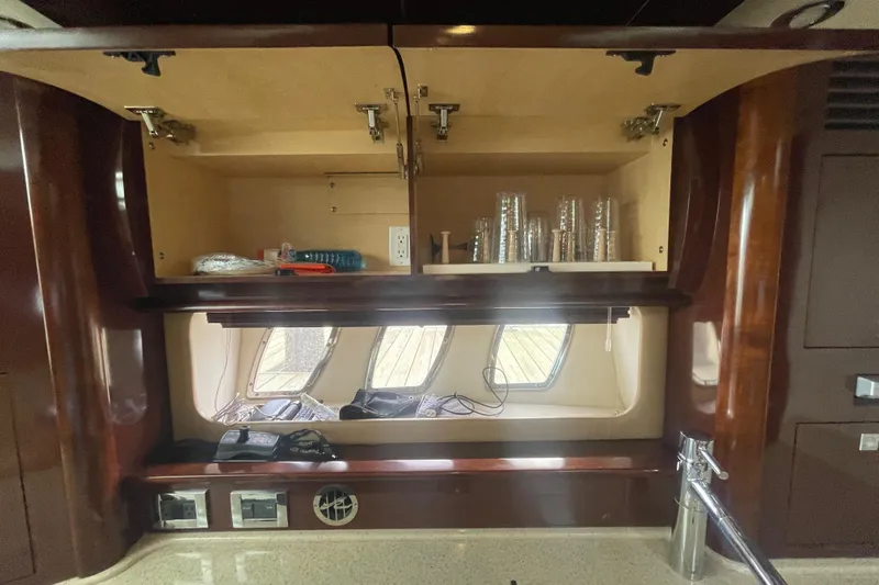 Maddie Janes Yacht Photos Pics Interior of 2009 Sea Ray 40 Sundancer with open cabinets and countertop.