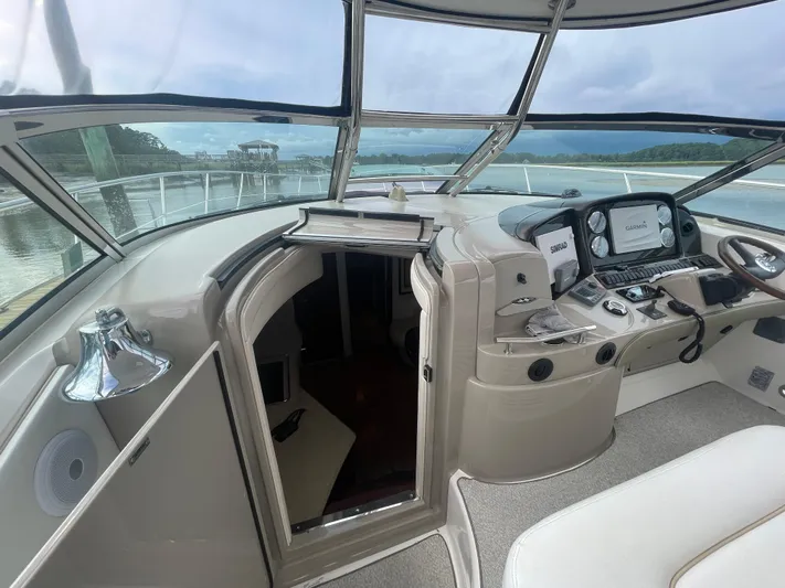 Maddie Janes Yacht Photos Pics 2009 Sea Ray 40 Sundancer helm with navigation equipment and open cabin door.