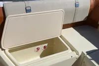 2023 Invictus GT280 boat interior with open storage compartment and Yamaha engine.