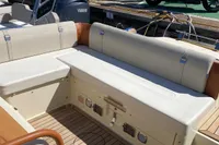 2023 Invictus GT280 boat interior with beige seating and wooden deck.