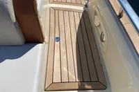 2023 Invictus GT280 boat deck with teak flooring and cushioned seating.