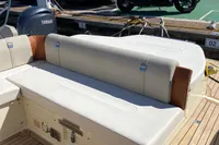 2023 Invictus GT280 boat interior with beige seating and Yamaha engine at marina.