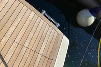 Teak deck of 2023 Invictus GT280 yacht with water and buoy.