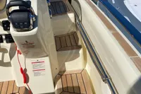 2023 Invictus GT280 boat interior with wooden steps and control panel.
