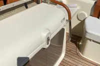 2023 Invictus GT280 boat interior with teak flooring and cushioned seating.