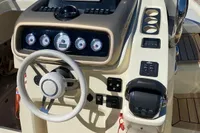 2023 Invictus GT280 boat dashboard with Garmin navigation system and control panel.