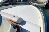 2023 Invictus GT280 boat with cushioned deck, docked at marina.