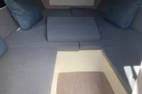2023 Invictus GT280 cabin interior with gray cushions and wooden flooring.