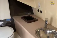 2023 Invictus GT280 yacht bathroom with modern sink and toilet.