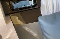 Interior of 2023 Invictus GT280 boat with window, curtain, and blue cushion.