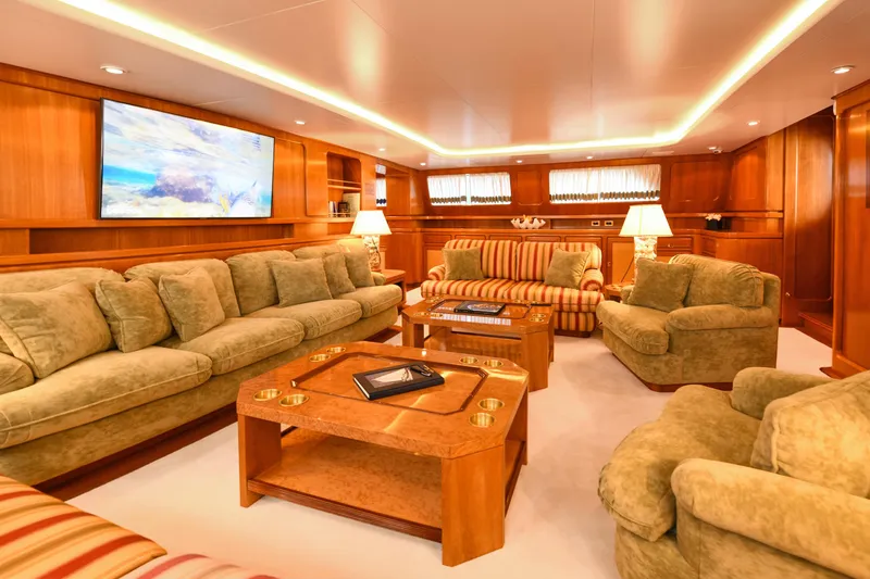 Tamarita Yacht Photos Pics Luxurious yacht interior with plush seating, wooden accents, and a large TV, Perini Navi 46, 1992.