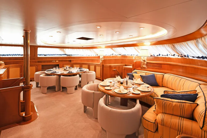 Tamarita Yacht Photos Pics Luxurious dining area on a 1992 Perini Navi 46 yacht, featuring elegant wood interiors.