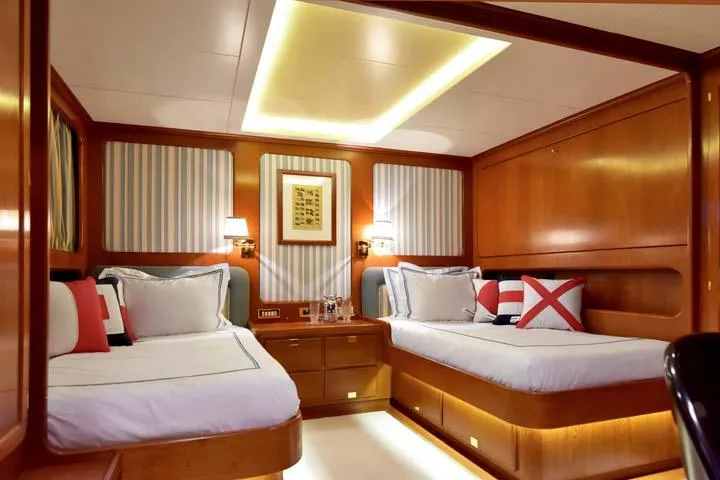 Tamarita Yacht Photos Pics Luxurious cabin interior of 1992 Perini Navi 46 yacht with twin beds and elegant decor.