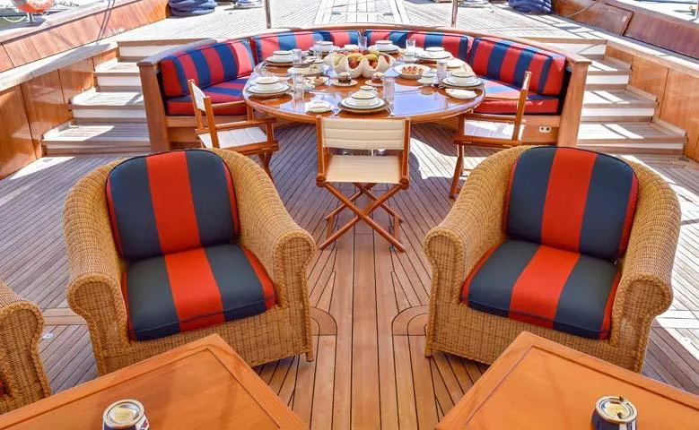 Tamarita Yacht Photos Pics Luxurious 1992 Perini Navi 46 yacht deck with elegant seating and dining setup.