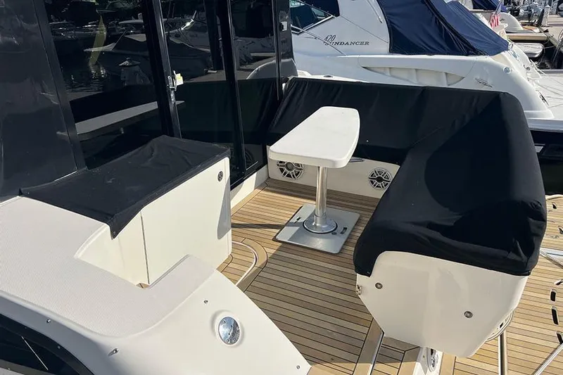  Yacht Photos Pics 2015 Sea Ray 470 Sundancer yacht deck with seating and table, docked at marina.