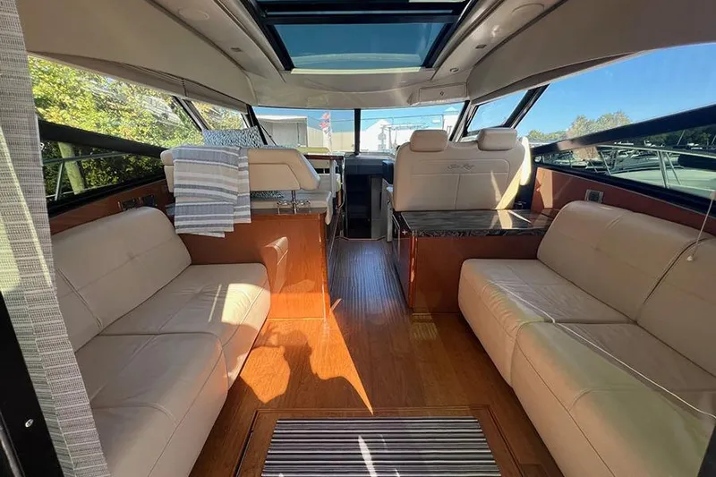  Yacht Photos Pics Interior of 2015 Sea Ray 470 Sundancer yacht with luxurious seating and wood flooring.