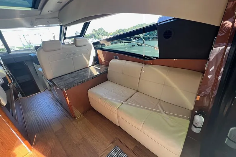  Yacht Photos Pics Luxurious interior of 2015 Sea Ray 470 Sundancer yacht with leather seating and wood accents.