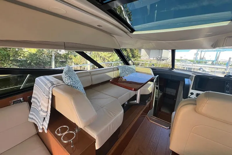  Yacht Photos Pics Interior of 2015 Sea Ray 470 Sundancer yacht with beige seating and skylight.
