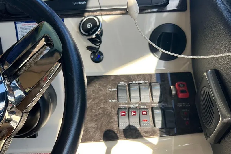  Yacht Photos Pics Control panel of a 2015 Sea Ray 470 Sundancer yacht with steering wheel and switches.