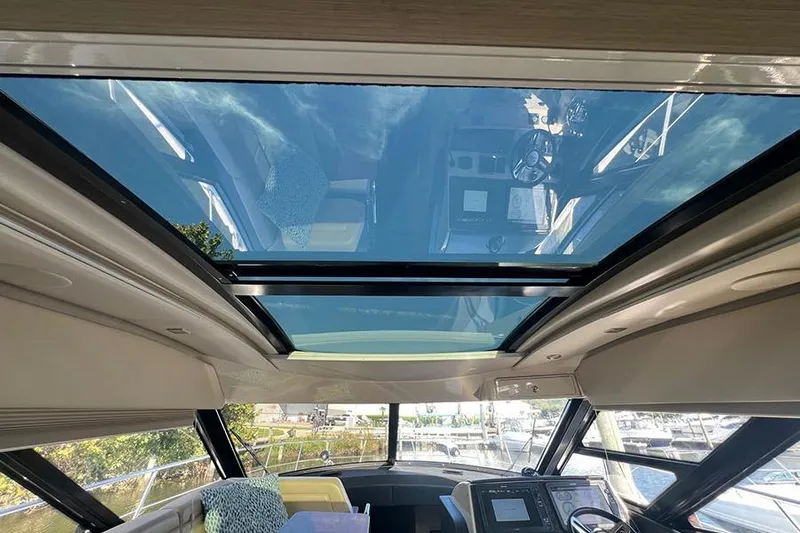  Yacht Photos Pics Interior view of 2015 Sea Ray 470 Sundancer with panoramic sunroof and modern helm.
