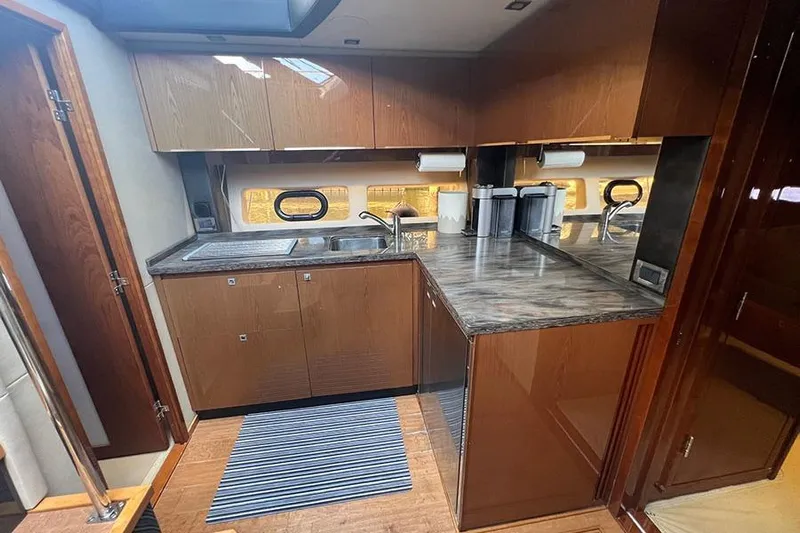  Yacht Photos Pics Luxurious kitchen interior of 2015 Sea Ray 470 Sundancer yacht with modern cabinetry and countertops.