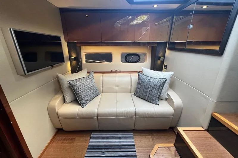  Yacht Photos Pics Luxurious interior of 2015 Sea Ray 470 Sundancer yacht with leather sofa and modern decor.