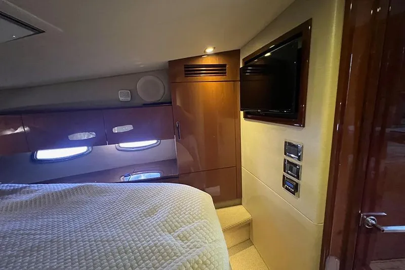  Yacht Photos Pics Luxurious cabin interior of 2015 Sea Ray 470 Sundancer yacht with TV and wood finishes.