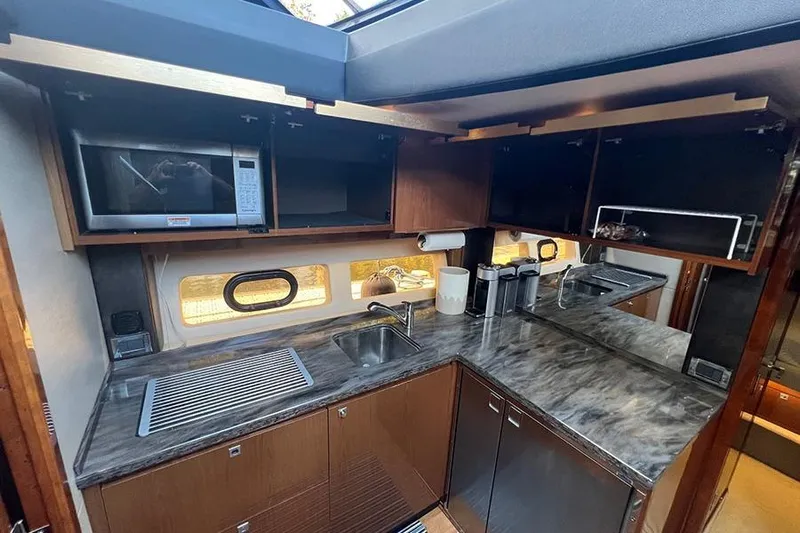  Yacht Photos Pics Luxurious kitchen interior of 2015 Sea Ray 470 Sundancer yacht with modern amenities.