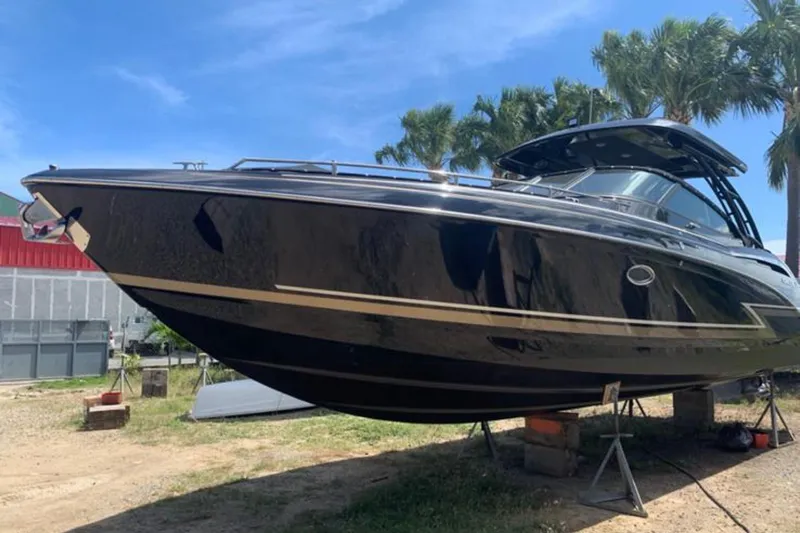 Cri Stellae Yacht Photos Pics 2018 Formula 350 Crossover Bowrider boat on stands, with palm trees in the background.