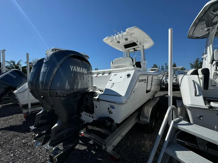  Yacht Photos Pics 2025 Tidewater 256 LXF boat with Yamaha engine, displayed outdoors on a trailer.