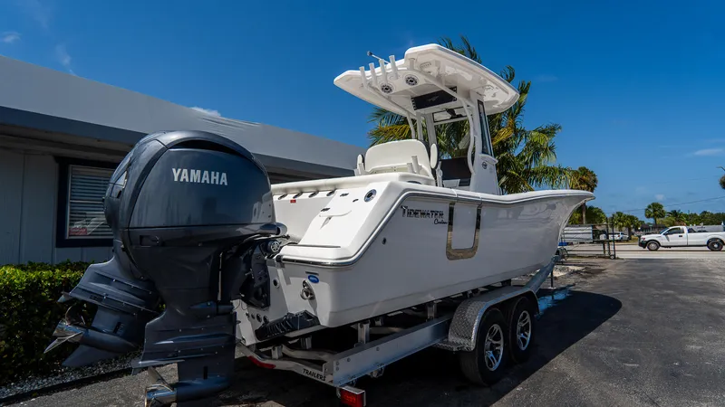  Yacht Photos Pics 2025 Tidewater 256 LXF boat with Yamaha engine on trailer, parked outdoors.